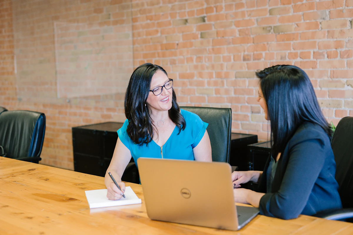 A realistic photograph of two professionals collaborating over business processes in a modern office.